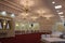 A large banquet hall with beautiful chandeliers hanging from the carved ceiling in the restaurant. A huge hall for special events