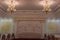 A large banquet hall with beautiful chandeliers hanging from the carved ceiling in the restaurant. A huge hall for special events