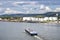 A large barge for the transport of liquid fuels on the Rhine in Germany. In the background, on the river bank, there are storage s