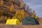 Large basecamp tents on colorful mountains background