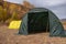 Large basecamp tents on colorful mountains background