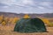 Large basecamp tents on colorful mountains background