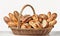 Large basket full of assorted breads isolated on white background