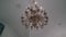 A large beautiful chandelier hangs from the ceiling of an Orthodox Christian Church. T