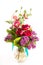 Large beautiful lush bouquet of flowers bright multicolored poppy, peony and lilac in a transparent vase on a white