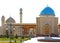 A large beautiful mosque with a large minaret and four small.