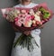 A large beautiful spreading bouquet of flowers in the hands of a girl, the work of a florist