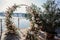 Large beautiful wedding arch on the lakeside ceremony