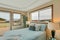 Large beige master bedroom with blue bedding