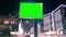 Large billboard wuth green screen for advertising on the modern building with neon lights, timelapse of traffic on busy