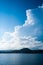 Large billowing clouds above coastal village