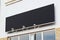 Large black billboard banner on a storefront mockup. Blank black restaurant or shop sign mock up template