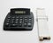 Large black calculator and a white slide rulers both used for ca