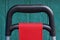 Large black plastic luggage handle with red cloth