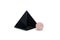 Large black pyramid of obsidian stone and small ball of rose quartz. Reiki concept. Isolated on white background