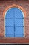 Large Blue Carriage Door in a Red Brick Wall