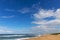 Large Blue Cloudy Sky and Distant city Coastal Skyline