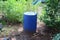 Large blue plastic bucket for water for agriculture.  Watering, placing in the outdoor garden on the ground.