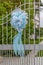 A large blue ribbon attached to the gate of a villa announces the birth of a newborn baby boy in the Italian tradition