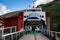 Large blue-and-white ship moored in the harbor of the village of Flam Norway