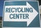 A large blue and white sign indicates a right turn for the recycling center