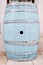 Large blue wooden barrel stands on a tile against the wall