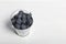 Large blueberries in a decorative bucket. International day without diets. On a white background. Close-up