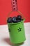 Large blueberries in a decorative bucket. Measuring tape for measuring the waist. International day without diets. Close-up