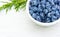 Large blueberries in a white cup on a white table. Copy space