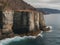 A large body of water next to a rocky cliff