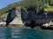 A large body of water next to a rocky cliff