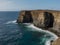 A large body of water next to a rocky cliff