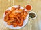 Large boiled shrimp on a large white plate with two sauces