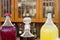 Large bottles of berry fruit drinks national liqueurs at the cafe on a street fair.