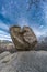 Large boulder of granite rock surounded by trees at Silla de Felipe II Phillip II chair in Guadarrama Mountains, Madrid, Spain