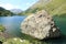 Large boulder in mountain lake