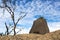A large boulder on a ridge, with blue, cloudy sky in the background, at Mt Buffalo, Vic, Aus.