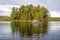 A Large Boulder Stands Before A Small Forested Island