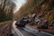 large boulders and mud covering road after landslide