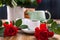 A large bouquet of red roses in a vase, and a cup of tea for a festive breakfast. Romantic Gift for women. The concept of St.