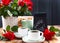 A large bouquet of red roses in a vase, and a cup of tea for a festive breakfast. Romantic Gift for women. The concept of St.