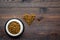 Large bowl of pet - cat food spilling in heart shape on wooden background top view mockup