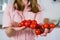 A large branch of red cherry tomato in the hands