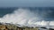 Large breaking wave at high tide