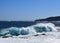 Large breaking wave hitting the shoreline with a big splash