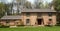 Large Brick Home with Flowering Crabapple Trees