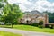 Large brick House in American suburb. Beautiful house with green lawn