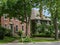 Large brick houses on shady street