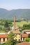 Large brick smokestack of a furnace and the hills