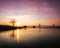 Large bridge crossing still body of water, reflections in the water. Throggs Neck Bridge, Queens New York